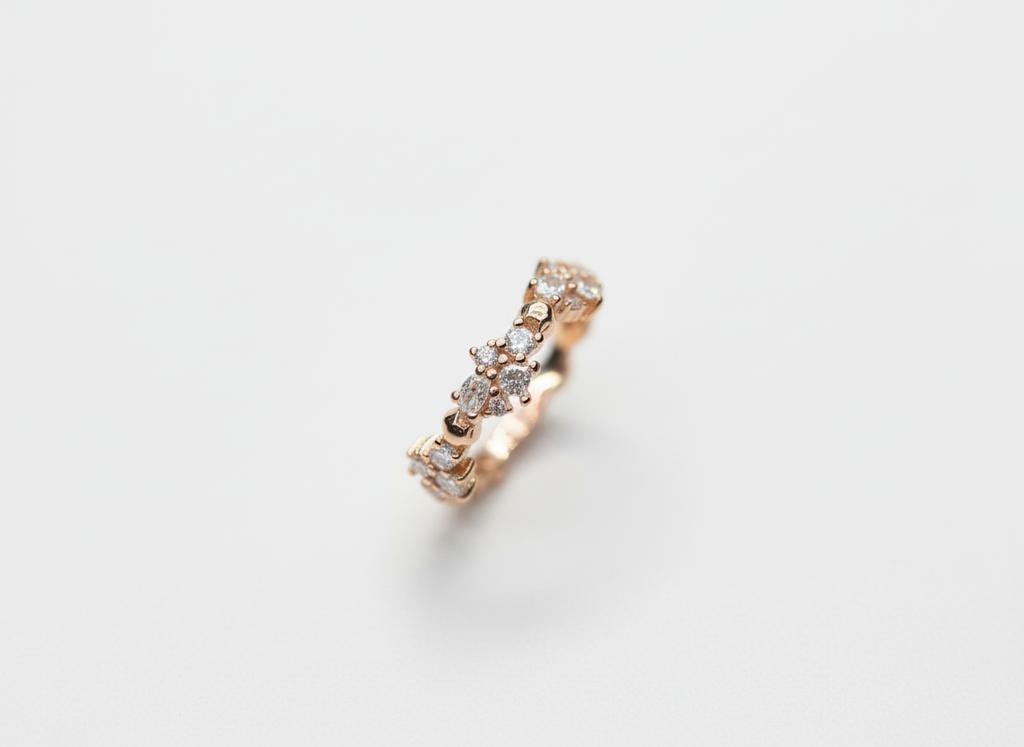 Top-down studio shot of an asymmetric rhythmic cluster ring isolated on a premium marble surface.