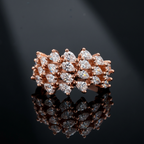 Editorial shot of a modern rose gold floral cluster ring designed with marquise and pear gems.