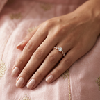 Editorial view of a model wearing a modern rose gold solitaire ring with a brilliant architectural silhouette.