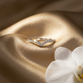 Front studio view of a polished silver chevron V ring featuring a sharp geometric silhouette lined with pavé stones.