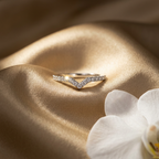 Front studio view of a polished silver chevron V ring featuring a sharp geometric silhouette lined with pavé stones.