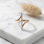 : Macro photo focusing on the tiny mechanical pivots and clean engineering of a gold spinning axis band ring.