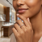 Editorial photography of a model showing an organic curved gold wave ring with a fluid silhouette.