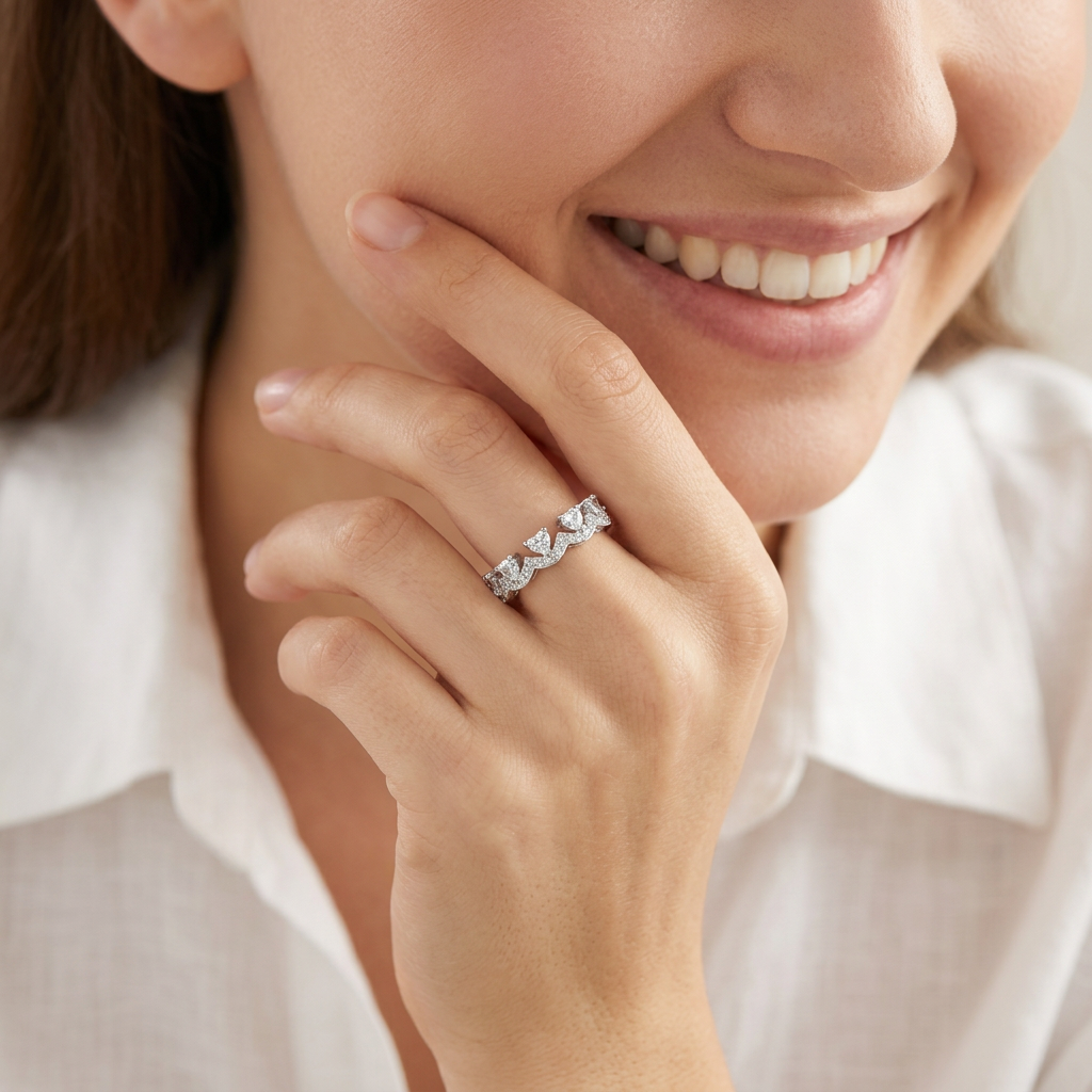 A contemporary jewelry hand stack anchoring an architectural silver chevron ring with slim silver companion bands.