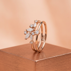 A curated fine jewelry hand stack pairing an asymmetrical gold orbital cluster ring with sleek minimal accent bands.