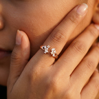 Macro close-up shot showcasing the precision pavé diamond settings on a fine rose gold open ring band.