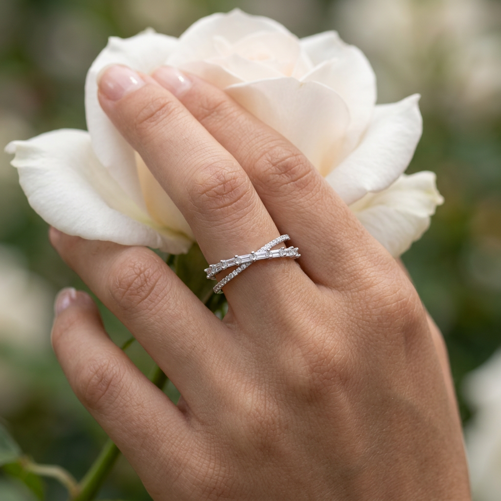 A polished silver crossover ring decorated with bright crystal gems