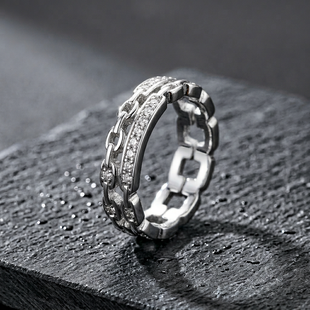 Front view of a cool toned silver interlocking link ring featuring sculptural bands and rows of clear pavé stones.