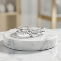 Front studio shot of a silver multi band knot ring featuring an interlaced silhouette with fine pavé diamond borders.