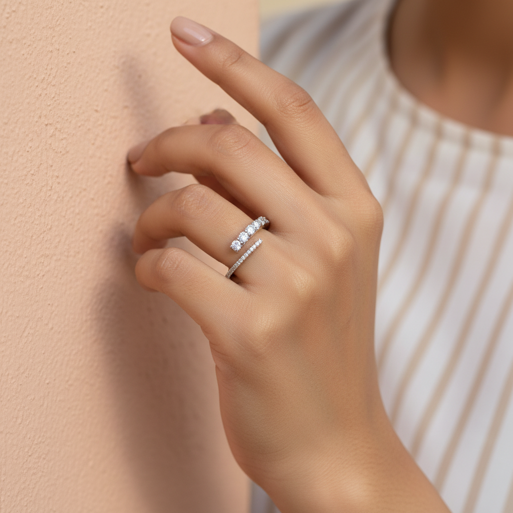Side angle of an open wrap diamond ring in sterling silver emphasizing its fluid architectural weight.
