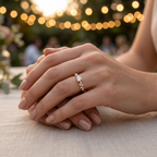 Side angle highlighting the unique architectural setting and graduated accent stones of a rose gold solitaire ring.