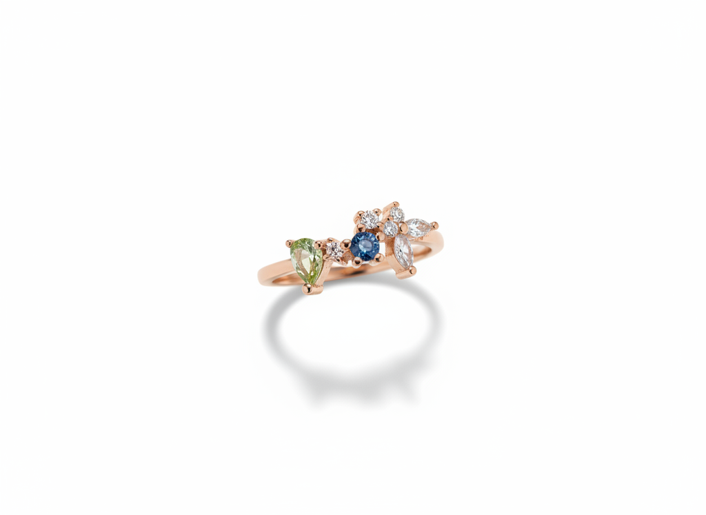 A curated hand stack matching an asymmetric blue gemstone cluster ring with plain rose gold companion bands.