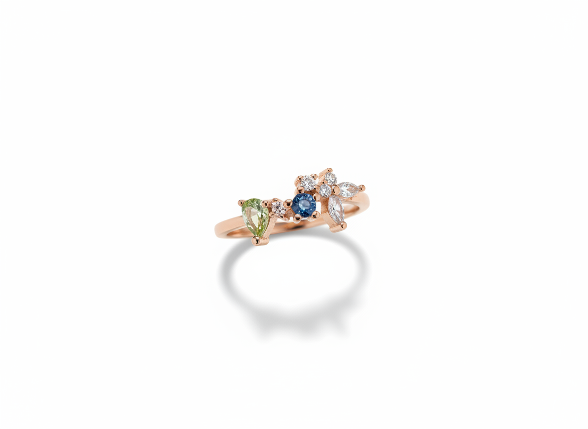 A curated hand stack matching an asymmetric blue gemstone cluster ring with plain rose gold companion bands.