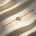 A delicate rose gold interlocking circle bracelet featuring white pavé stones on a fine cable chain.