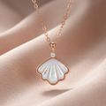A lustrous mother of pearl shell necklace from an elegant polished rose gold chain.