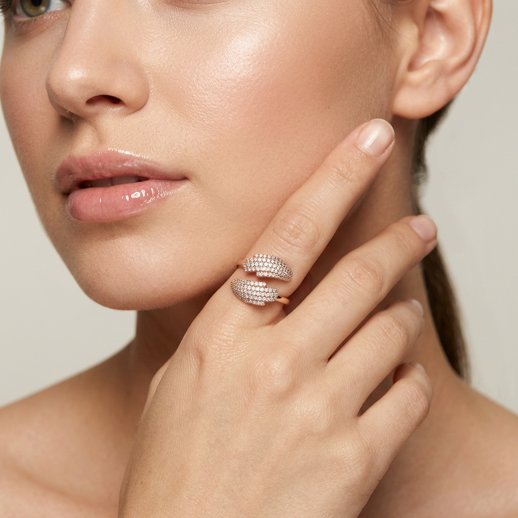 A curated fine jewelry stack layering sleek rose gold bands alongside a sculptural open bypass ring style.