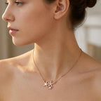 A lifestyle view of an asymmetrical rose gold starfish necklace catching the light gracefully on women.