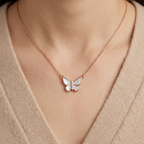 An architectural rose gold butterfly pendant cradling luminous pearls, designed as a modern luxury statement.