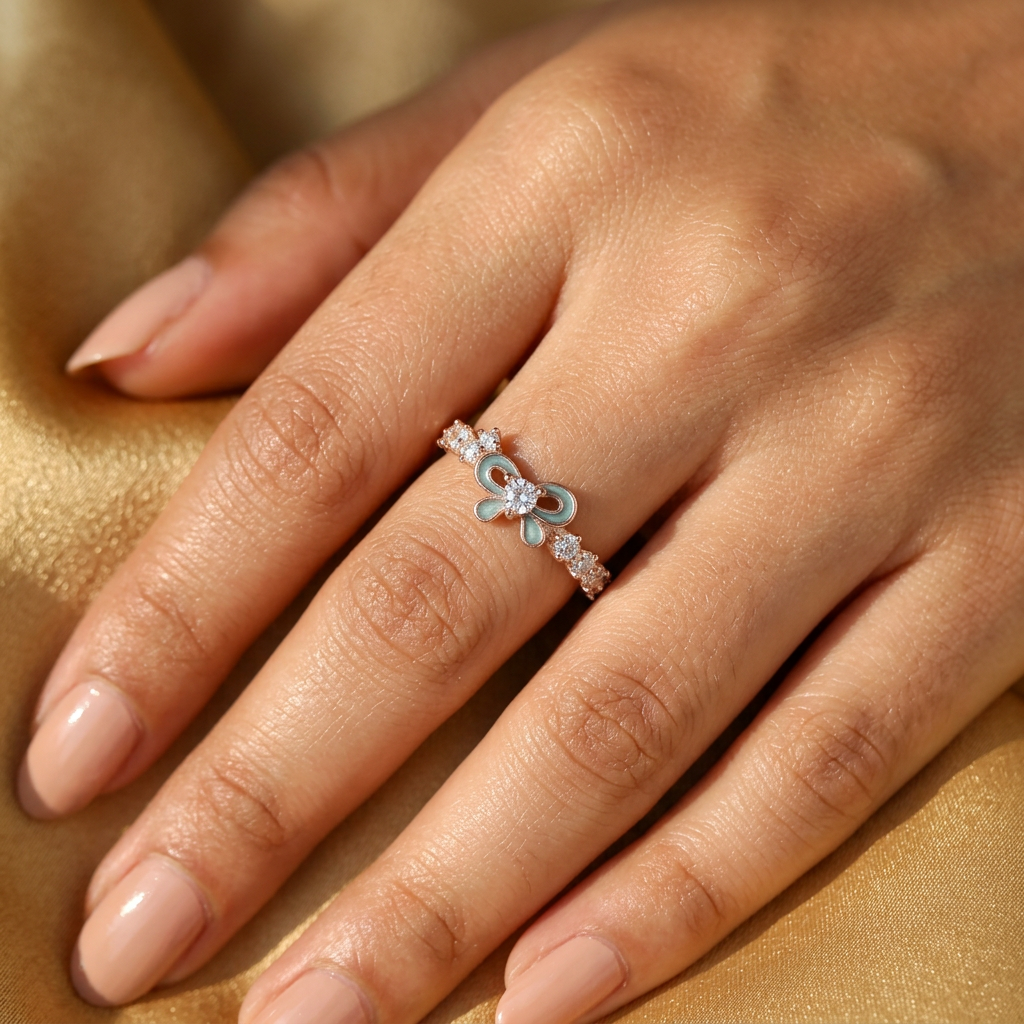 Sculptural gold ribbon ring showing the high-polish finish and fine setting of the blue stone.