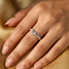 Sculptural gold ribbon ring showing the high-polish finish and fine setting of the blue stone.