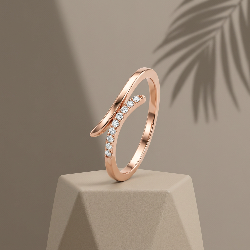 A sculptural rose gold open ring featuring a fluid bypass silhouette accented with a delicate path of pavé stones.