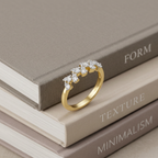 A polished yellow gold ring featuring an organic, jagged cluster of brilliant diamonds in a modern silhouette.