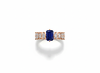 Side view displaying the tiered rose gold setting and deep hue of an indigo emerald cut gem evening ring.