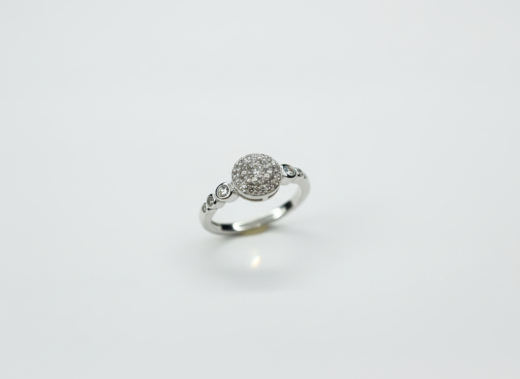 Side angle highlighting the sharp dimensional silhouette and rhythmic textured flow of a silver round ring.