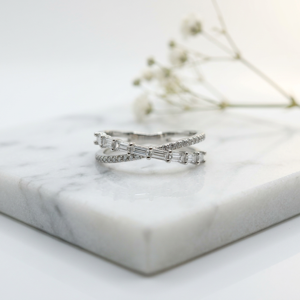 Side angle highlighting the structural profile, high polish metal finish, and intersecting bands of a silver crossover ring.
