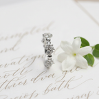 Side profile angle highlighting the dimensional structure and fluid, luminous appeal of a sculptural crystal ring.