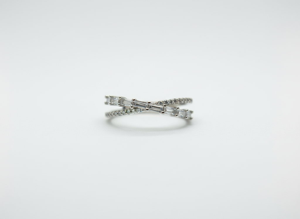 Real-world perspective showing a dual-line silver crossover ring