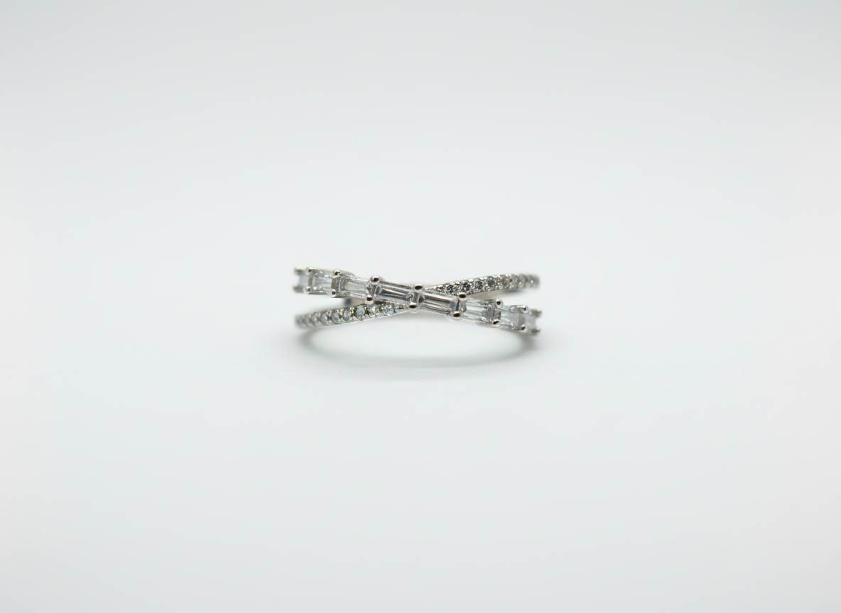 Real-world perspective showing a dual-line silver crossover ring