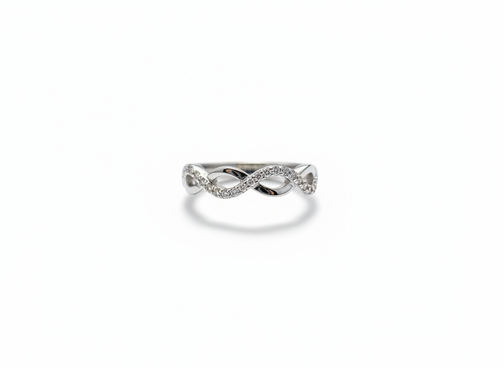 Real-world perspective showing a slender silver diamond infinity ring on a hand to illustrate its delicate width.