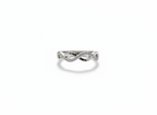 Real-world perspective showing a slender silver diamond infinity ring on a hand to illustrate its delicate width.