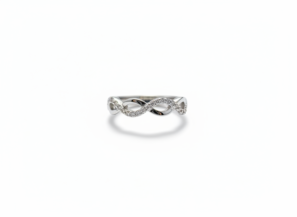 Real-world perspective showing a slender silver diamond infinity ring on a hand to illustrate its delicate width.