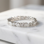 Polished sterling silver band showcasing an alternating sequence of marquise and round diamonds in a sharp silhouette.