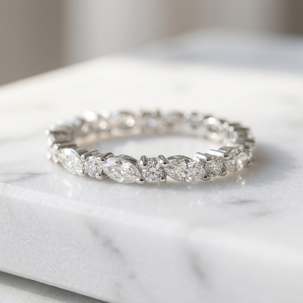 Polished sterling silver band showcasing an alternating sequence of marquise and round diamonds in a sharp silhouette.