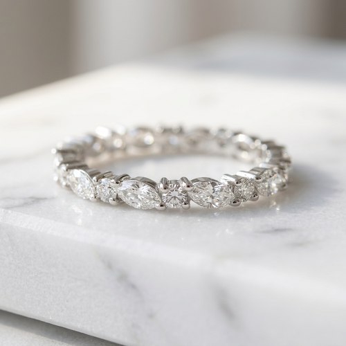 Polished sterling silver band showcasing an alternating sequence of marquise and round diamonds in a sharp silhouette.