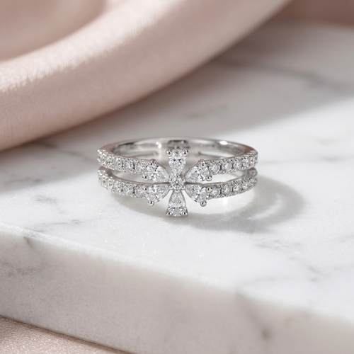 Macro photograph of the astral bloom ring showing the sharp radiating gold petals surrounding a cluster of pavé diamonds.
