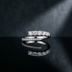High-polish sterling silver bypass ring featuring a continuous stream of precision-set round diamonds.