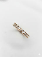 An elegant fine jewelry rose gold baguette ring with sharp geometric textures, styled as a premium holiday gift.