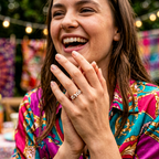 Rose gold butterfly pearl ring styled within a curated stack of minimalist bands, adding a luminous energy to the look.