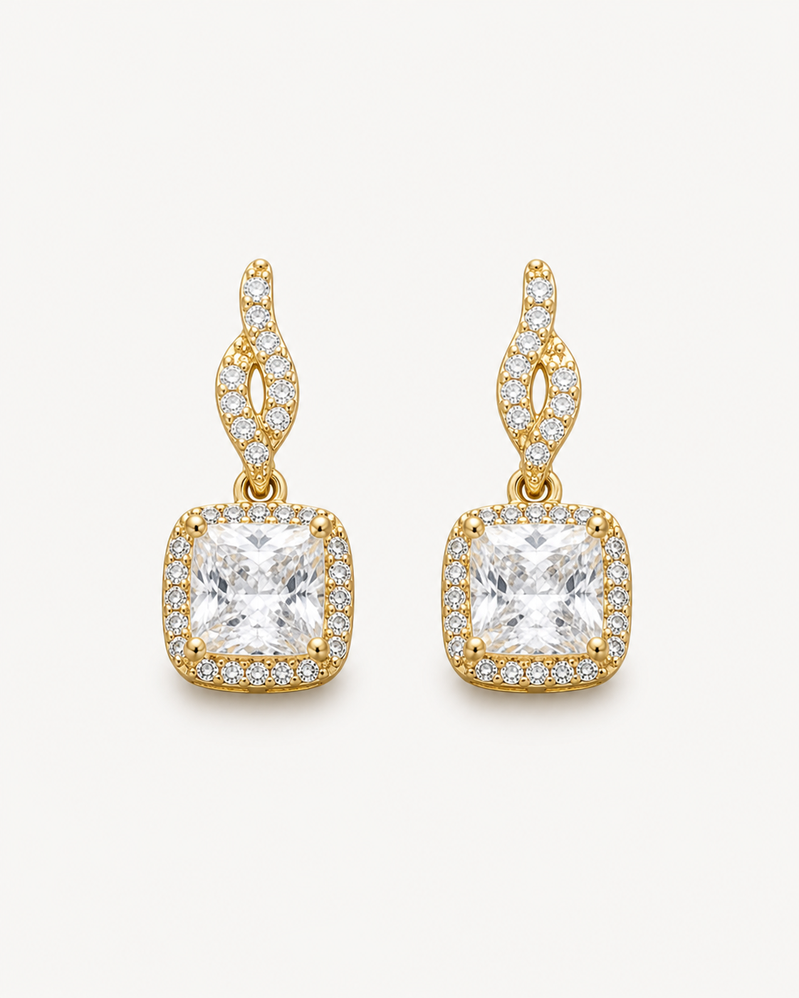 Warm-metal curved cushion drop earrings on Oyster Silk.
