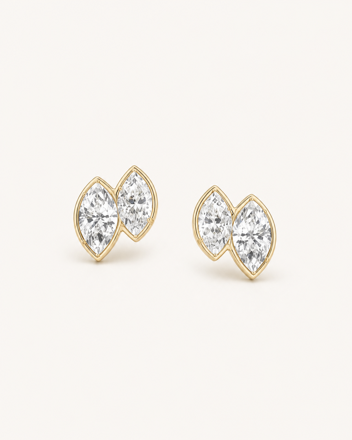 Warm-metal double marquise stud earrings on Oyster Silk.