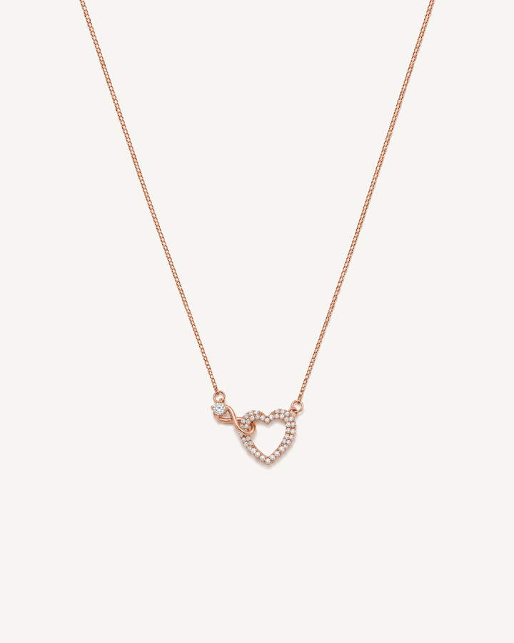 Rose gold infinity heart necklace with pavé diamonds and a round solitaire