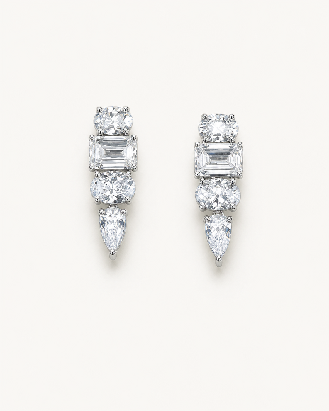 White-metal mixed-cut drop earrings on Oyster Silk.