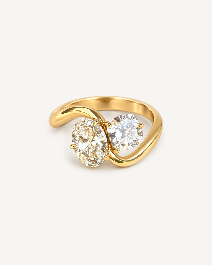 Oval Bypass Ring in yellow gold with oval and round stones on Oyster Silk.