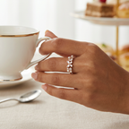 Front view of the pearl ring showcasing an intricate butterfly design paired with lustrous pearls and a pear-cut lab-grown diamond.
