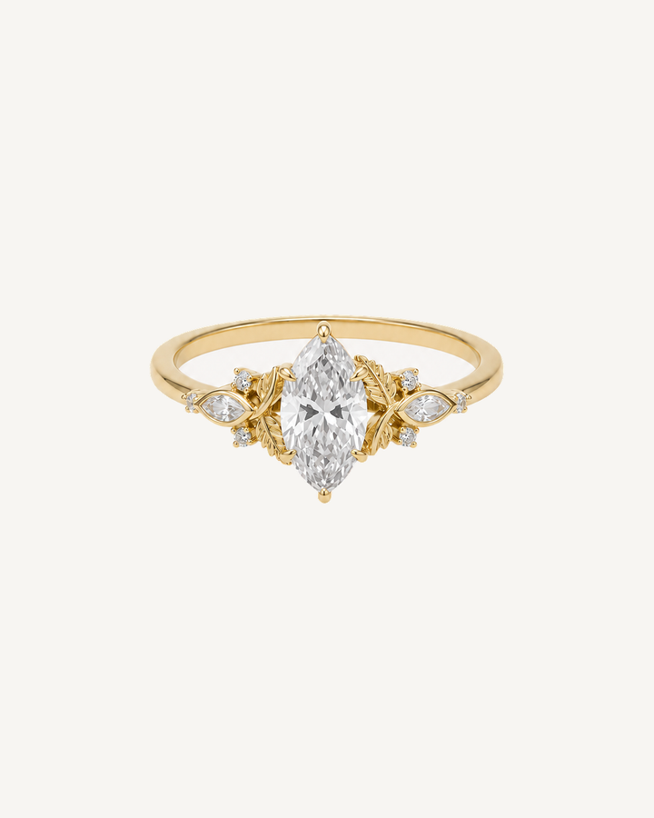 Yellow gold ring with a clear marquise centre stone and yellow gold petals