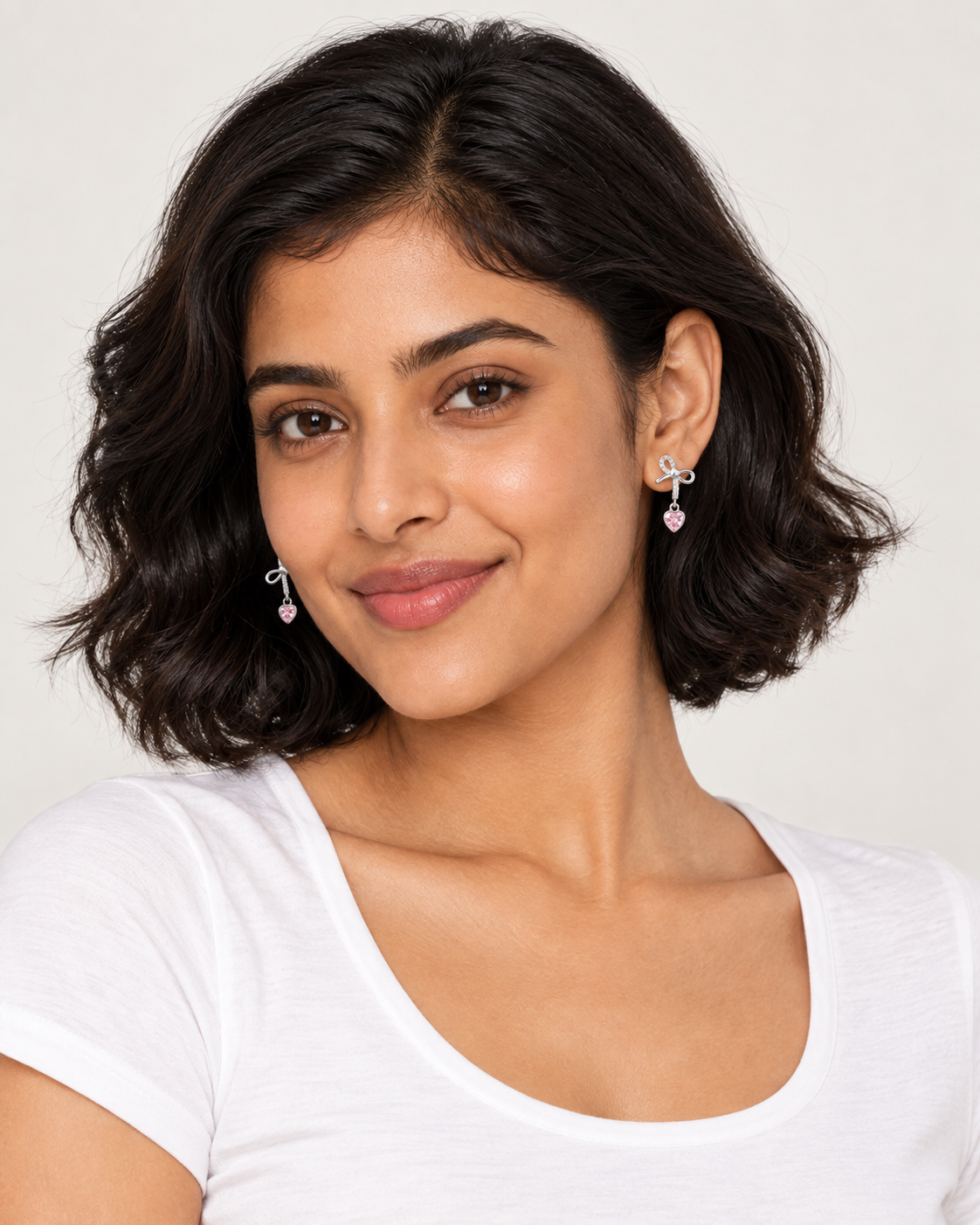 Bow Heart Drop Earrings — worn studio view